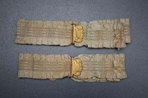 Ruffled elastic garters with gilt monogrammed adjusters, c. 1910s, USA. Photography by Tigz Rice Studios. From The Underpinnings Museum collection.