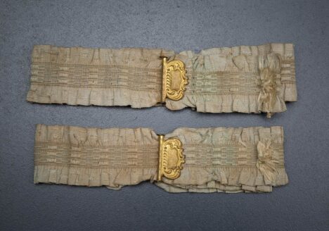 Ruffled elastic garters with gilt monogrammed adjusters, c. 1910s, USA. Photography by Tigz Rice Studios. From The Underpinnings Museum collection.