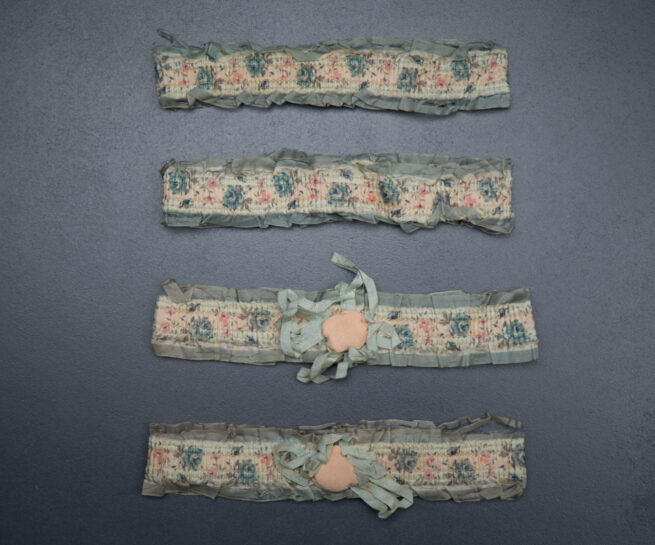 1920s floral ribbon garters with padding and rosettes, c. 1920s. USA Photography by Tigz Rice Studios. From The Underpinnings Museum collection.
