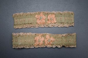 Green ribbon garters with crochet trim and French knot embroidery, 1920s, USA Photography by Tigz Rice Studios. From The Underpinnings Museum collection.