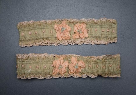 Green ribbon garters with crochet trim and French knot embroidery, 1920s, USA Photography by Tigz Rice Studios. From The Underpinnings Museum collection.