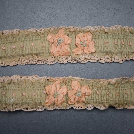 Green ribbon garters with crochet trim and French knot embroidery, 1920s, USA Photography by Tigz Rice Studios. From The Underpinnings Museum collection.
