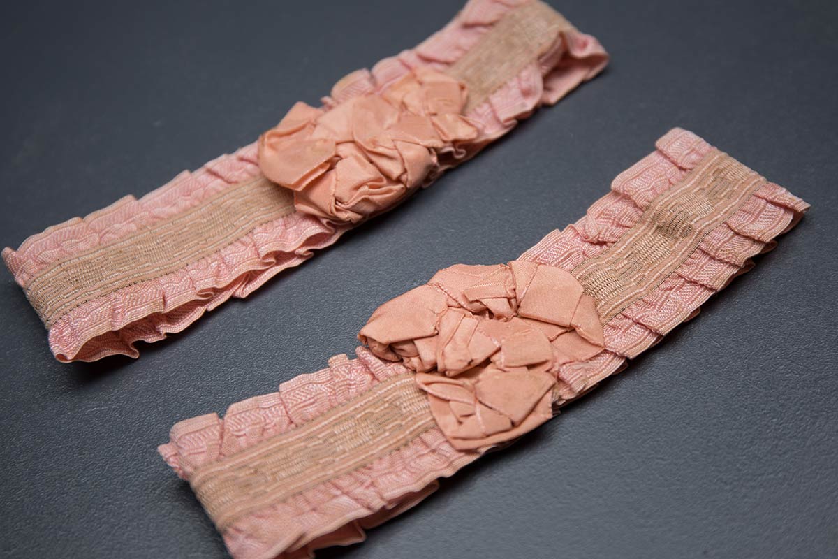 Pink ruffle elastic garters with silk rosettes, c. 1920s, USA Photography by Tigz Rice Studios. From The Underpinnings Museum Collection.