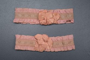 Pink ruffle elastic garters with silk rosettes, c. 1920s, USA Photography by Tigz Rice Studios. From The Underpinnings Museum Collection.