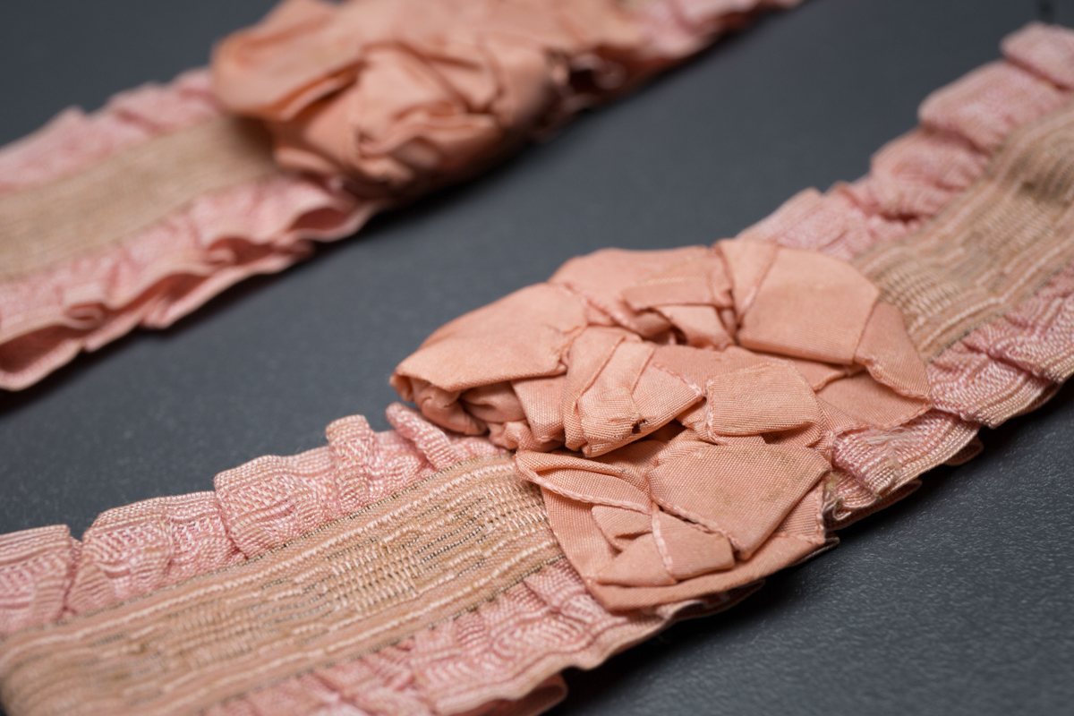 Pink ruffle elastic garters with silk rosettes, c. 1920s, USA Photography by Tigz Rice Studios. From The Underpinnings Museum Collection.