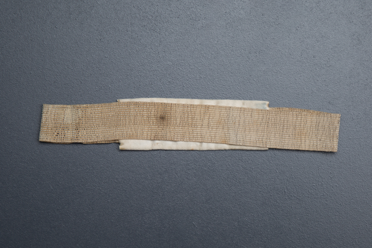 Cross stitch wedding garter, belonged to Mrs Clara Jane Wreford-Brown, 1864, Great Britain. From The Underpinnings Museum collection. Photography by Tigz Rice.