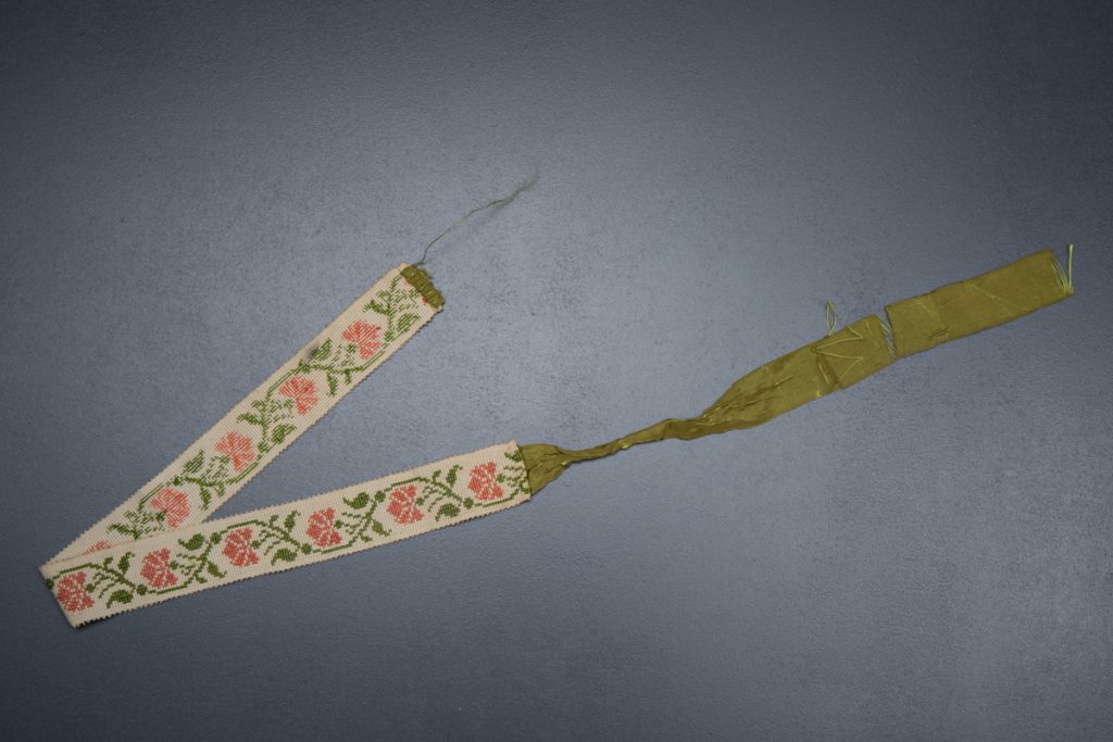 Cross stitch garter with ribbon tie, c. 1820s. From The Underpinnings Museum collection Photography by Tigz Rice