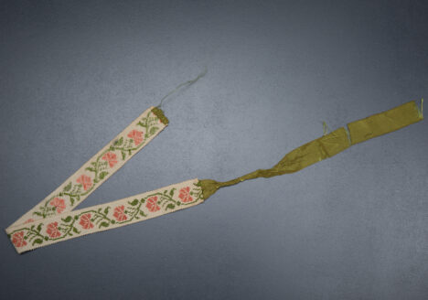 Cross stitch garter with ribbon tie, c. 1820s. From The Underpinnings Museum collection Photography by Tigz Rice