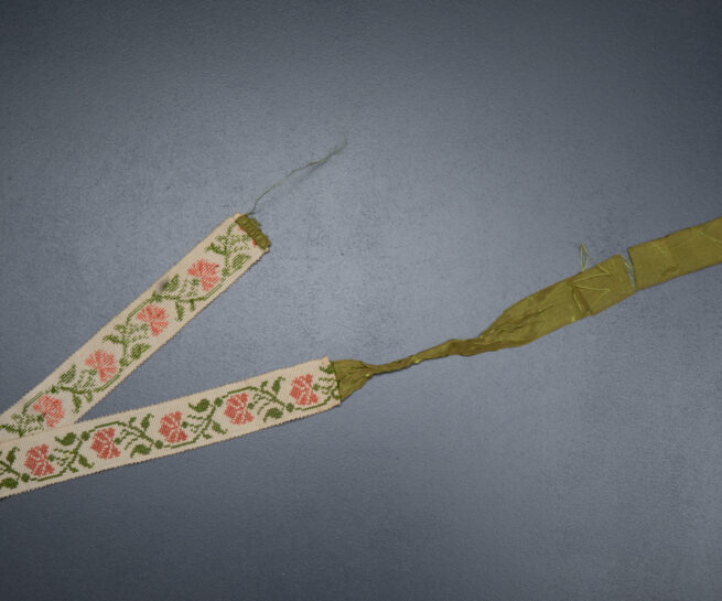Cross stitch garter with ribbon tie, c. 1820s. From The Underpinnings Museum collection Photography by Tigz Rice