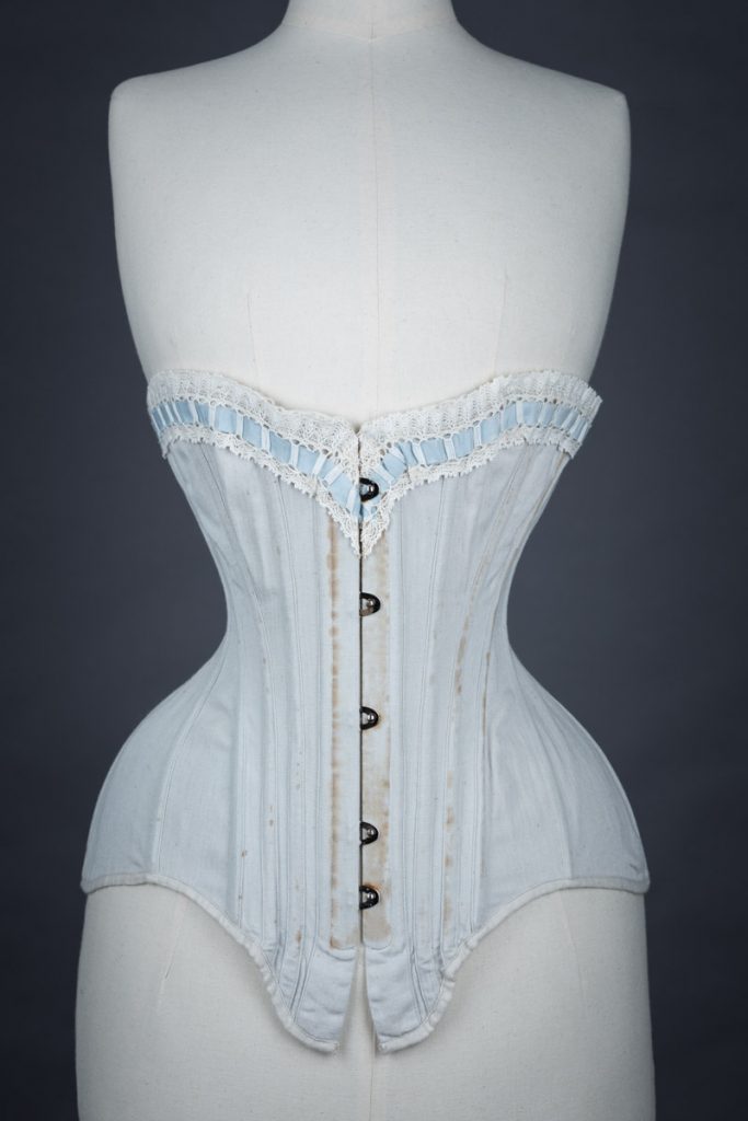 Grey herringbone coutil corset with ribbon slot lace trim, c. 1900-5, France. From The Underpinnings Museum collection. Photography by Tigz Rice.