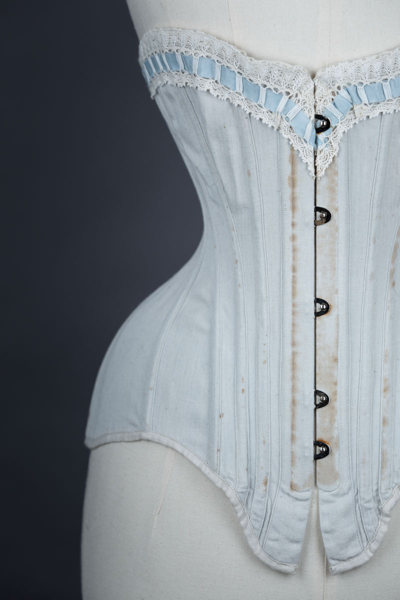 Grey herringbone coutil corset with ribbon slot lace trim, c. 1900-5, France. From The Underpinnings Museum collection. Photography by Tigz Rice.