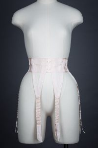 Pink Grosgrain Ribbon Suspender Belt, c. 1910s. The Underpinnings Museum. Photo by Tigz Rice