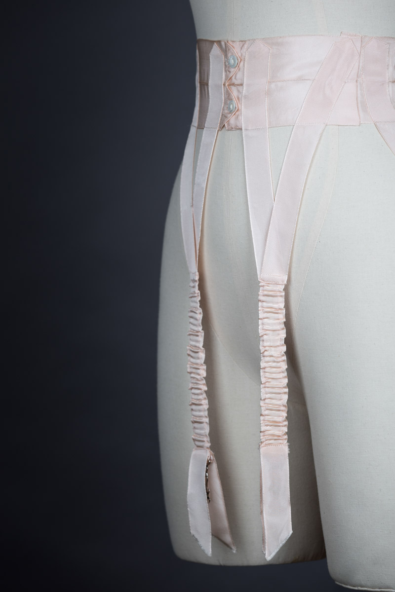 Pink Grosgrain Ribbon Suspender Belt, c. 1910s. The Underpinnings Museum. Photo by Tigz Rice