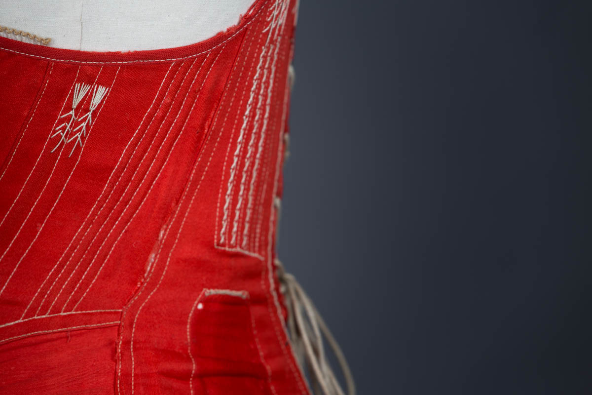 Red midbust corset with flossing and gores, c.1860s From The Underpinning Museum collection Photography by Tigz Rice