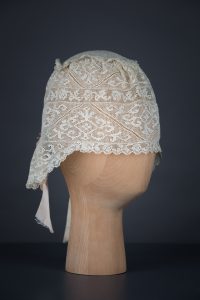Filet lace boudoir cap, c. 1910s, GB. The Underpinnings Museum. Photo by Tigz Rice