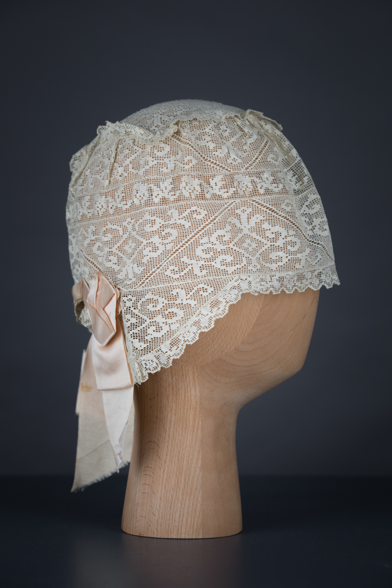 Filet lace boudoir cap, c. 1910s, GB. The Underpinnings Museum. Photo by Tigz Rice