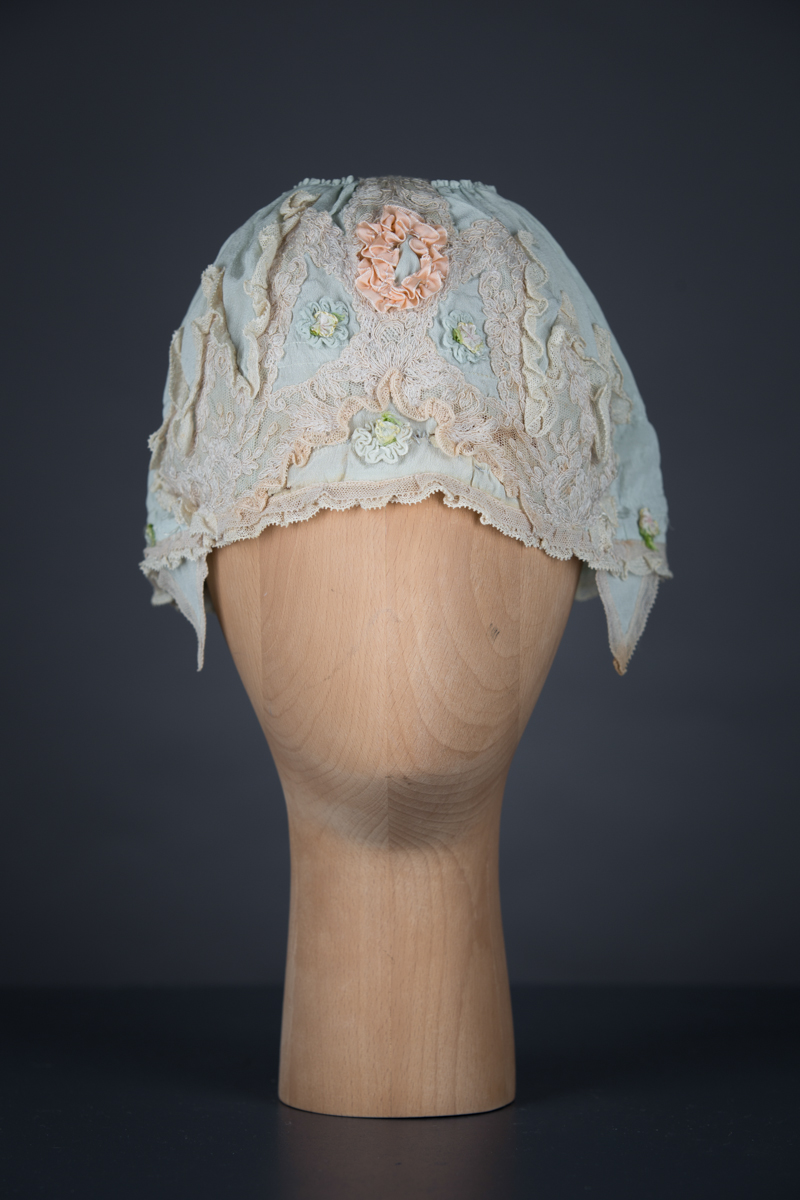 Pale blue silk boudoir cap with ribbonwork and lace, c. 1920s, GB. The Underpinnings Museum. Photo by Tigz Rice