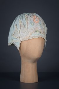 Pale blue silk boudoir cap with ribbonwork and lace, c. 1920s, GB. The Underpinnings Museum. Photo by Tigz Rice