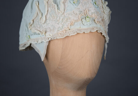 Pale blue silk boudoir cap with ribbonwork and lace, c. 1920s, GB. The Underpinnings Museum. Photo by Tigz Rice