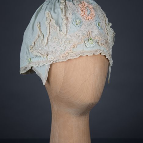 Pale blue silk boudoir cap with ribbonwork and lace, c. 1920s, GB. The Underpinnings Museum. Photo by Tigz Rice