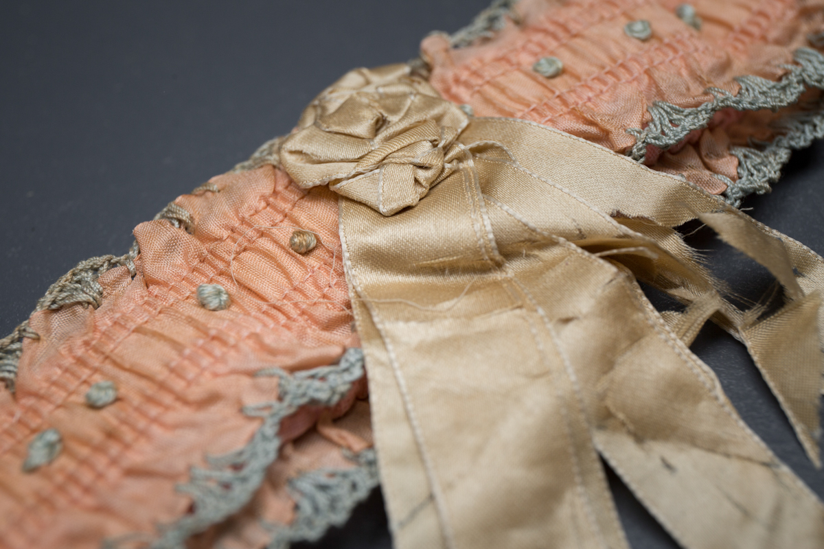 Pink Ribbon Garter With Blue Crochet Trim & Cream Rosette, c. 1920s, USA. The Underpinnings Museum. Photography by Tigz Rice