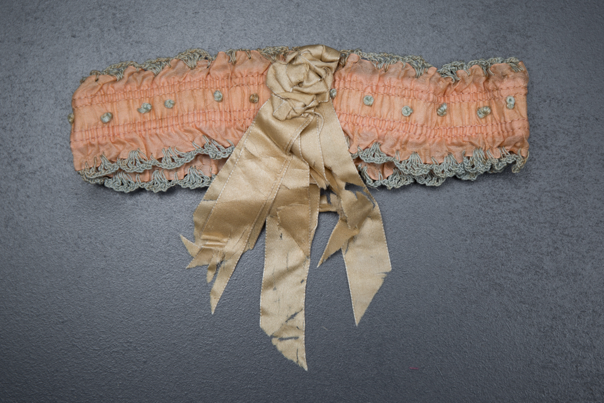 Pink Ribbon Garter With Blue Crochet Trim & Cream Rosette, c. 1920s, USA. The Underpinnings Museum. Photography by Tigz Rice