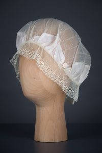 Silk Habotai & Lace Boudoir Cap With Silk Rosettes, c.1920s, UK. The Underpinnings Museum. Photography by Tigz Rice