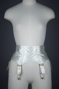 Ivory Quilted Satin Suspender Belt With Button Fastening, c. 1940s, Great Britain. The Underpinnings Museum. Photography by Tigz Rice