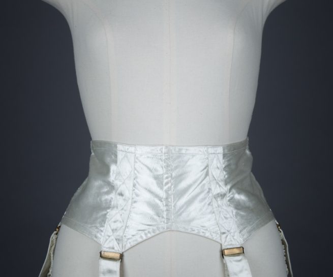 Ivory Quilted Satin Suspender Belt With Button Fastening, c. 1940s, Great Britain. The Underpinnings Museum. Photography by Tigz Rice