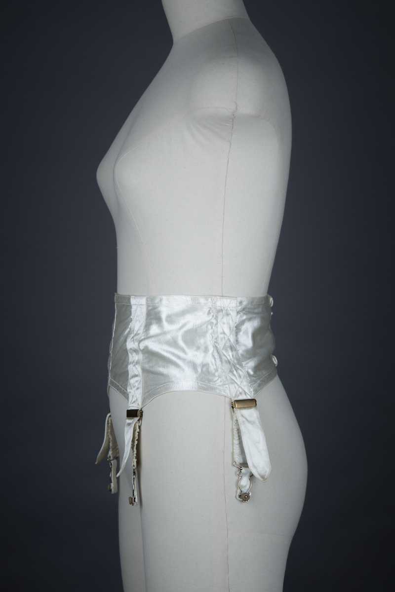 Ivory Quilted Satin Suspender Belt With Button Fastening, c. 1940s, Great Britain. The Underpinnings Museum. Photography by Tigz Rice