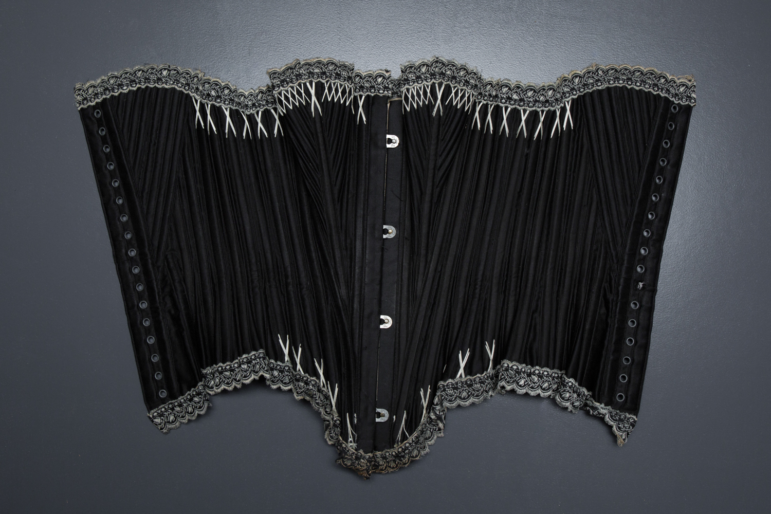 Black Cotton Sateen Corset With White Flossing & Woven Trim by P. N., C. late 1880s - early 1890s, USA. The Underpinnings Museum. Photography by Karolina Laskowska