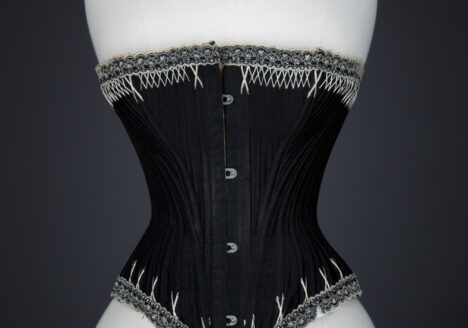 Black Cotton Sateen Corset With White Flossing & Woven Trim by P. N., C. late 1880s - early 1890s, USA. The Underpinnings Museum. Photography by Karolina Laskowska