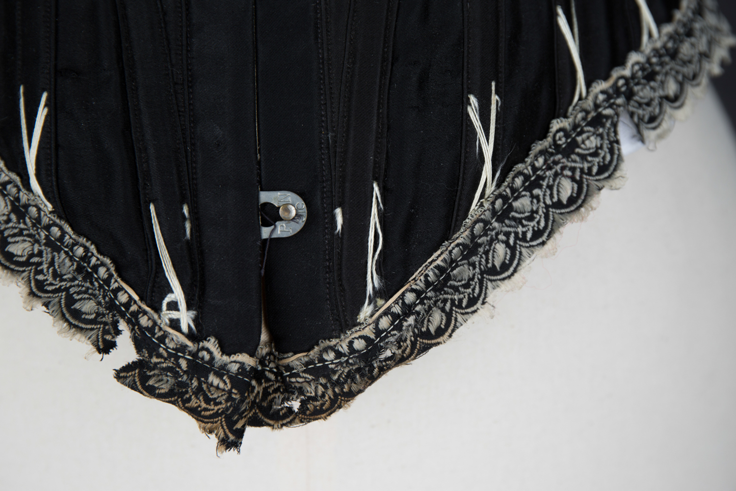 Black Cotton Sateen Corset With White Flossing & Woven Trim by P. N., C. late 1880s - early 1890s, USA. The Underpinnings Museum. Photography by Karolina Laskowska