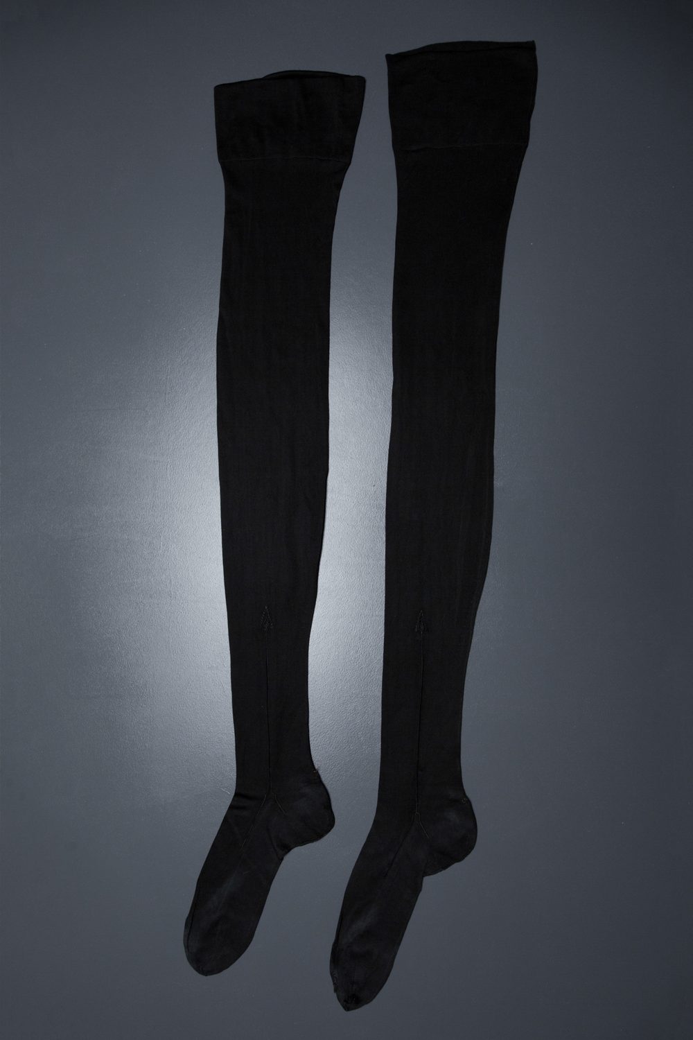 Black silk stockings, purchased with black Silk Underbust Corset With Suspenders & Ribbonwork by Corsets "Guy", c. 1920s, France. The Underpinnings Museum. Photography by Tigz Rice.