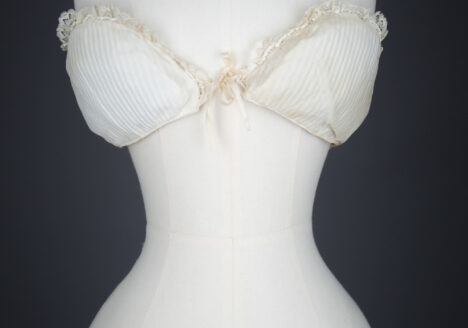 Cotton Padded Bust Improver With Lace Trim, c. 1880-1900s. The Underpinnings Museum. Photography by Tigz Rice.