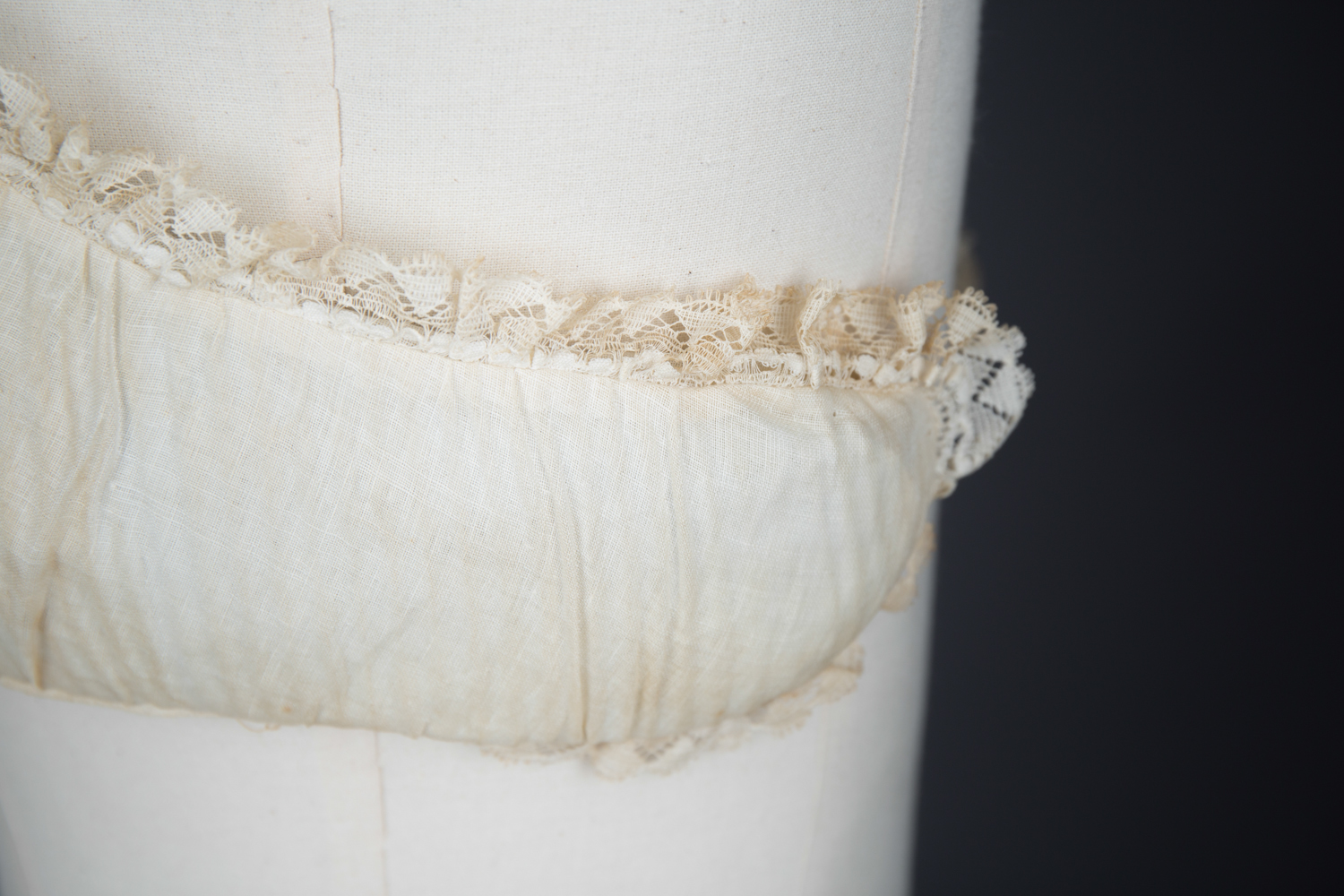 Cotton Padded Bust Improver With Lace Trim, c. 1880-1900s. The Underpinnings Museum. Photography by Tigz Rice.