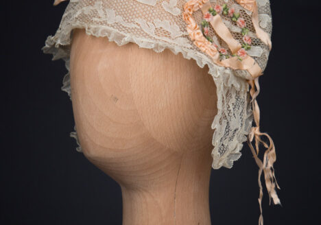 Cream Machine Lace Boudoir Cap With Silk Ribbonwork & Wired Ear Covers, c. 1920s, Great Britain. The Underpinnings Museum. Photography by Tigz Rice