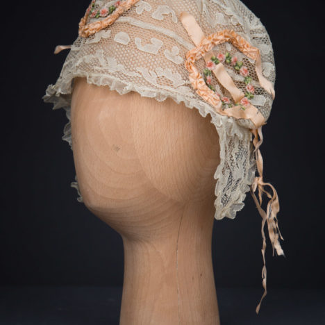 Cream Machine Lace Boudoir Cap With Silk Ribbonwork & Wired Ear Covers, c. 1920s, Great Britain. The Underpinnings Museum. Photography by Tigz Rice