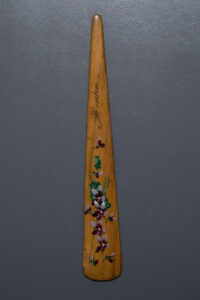 Hand Painted Souvenir 'Menton' Wooden Busk, c. 1850s, possibly France. The Underpinnings Museum. Photography by Tigz Rice