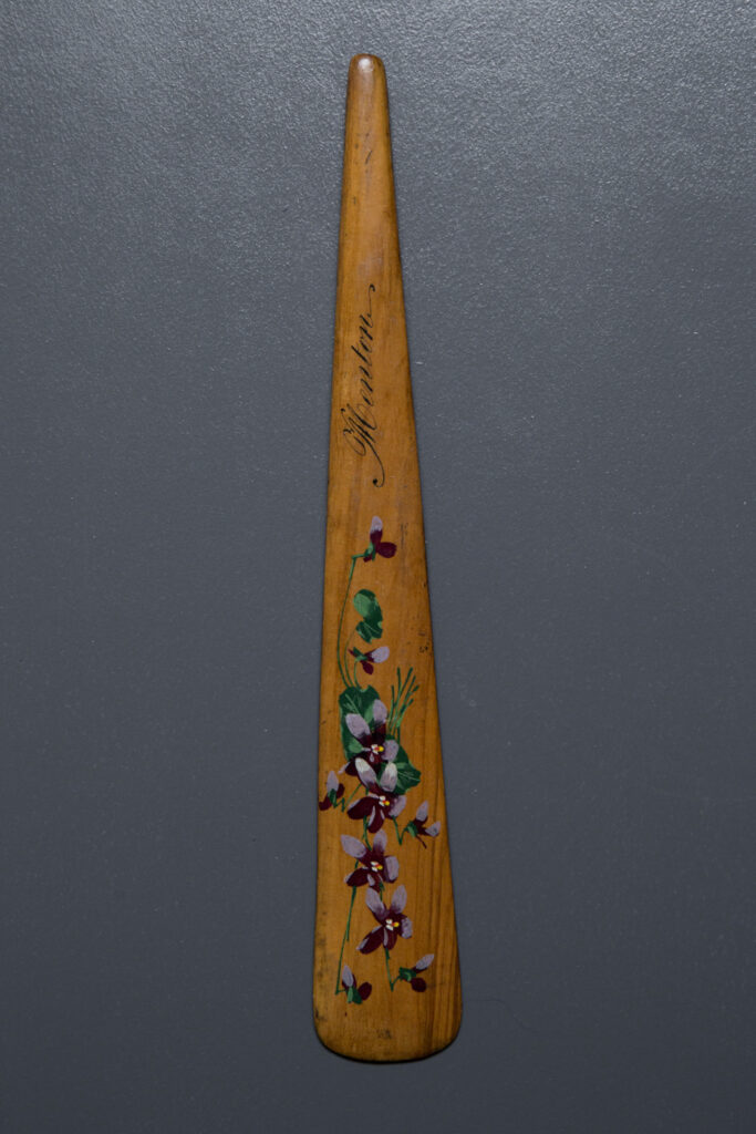 Hand Painted Souvenir 'Menton' Wooden Busk, c. 1850s, possibly France. The Underpinnings Museum. Photography by Tigz Rice