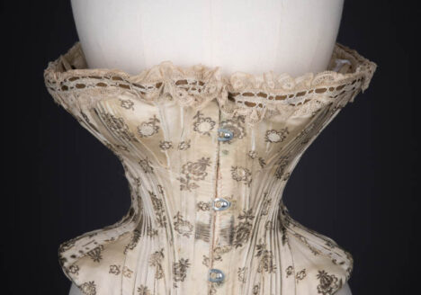 Metal & Silk Brocade Corset With Ribbon Slot Lace Trim, c. 1900s. The Underpinnings Museum. Photography by Tigz Rice