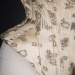 Metal & Silk Brocade Corset With Ribbon Slot Lace Trim, c. 1900s. The Underpinnings Museum. Photography by Tigz Rice