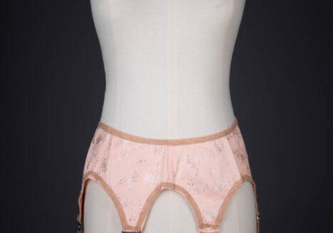 Tea Rose Floral Brocade Suspender With Ruffled Straps, c. 1920s, USA. The Underpinnings Museum. Photography by Tigz Rice.