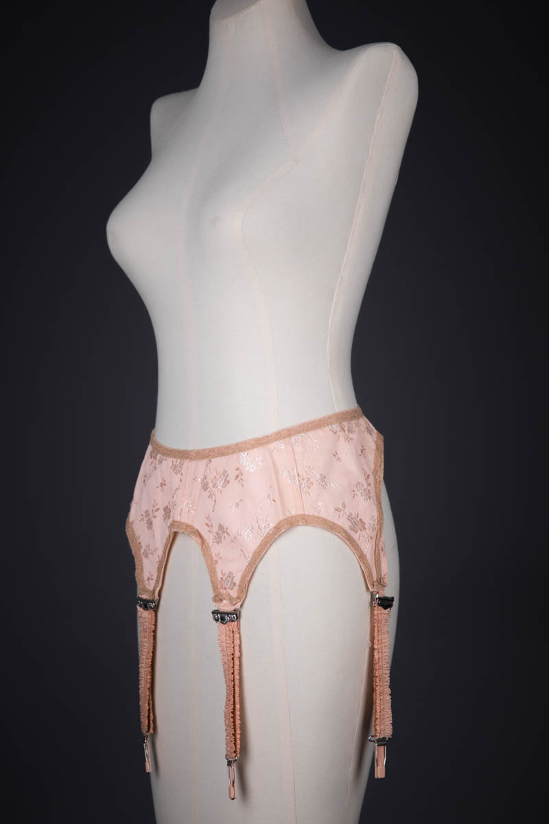Tea Rose Floral Brocade Suspender With Ruffled Straps, c. 1920s, USA. The Underpinnings Museum. Photography by Tigz Rice.