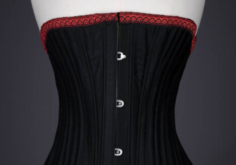 Black Cotton Sateen Corded Corset With Woven Trim, c. 1890s, Great Britain. The Underpinnings Museum. Photography by Tigz Rice.