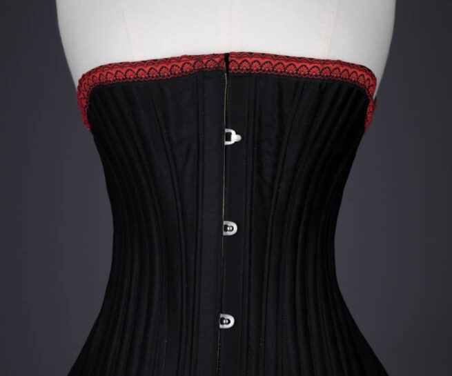 Black Cotton Sateen Corded Corset With Woven Trim, c. 1890s, Great Britain. The Underpinnings Museum. Photography by Tigz Rice.