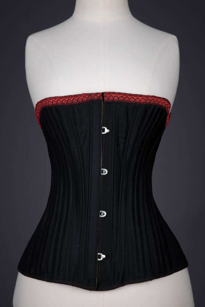 Black Cotton Sateen Corded Corset With Woven Trim, c. 1890s, Great Britain. The Underpinnings Museum. Photography by Tigz Rice.