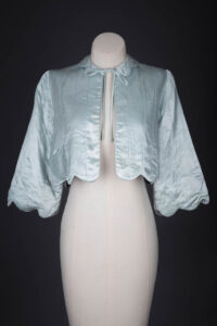 Satin Scalloped Hem Quilted Bed Jacket, c. 1940s, Great Britian. The Underpinnings Museum. Photography by Tigz Rice