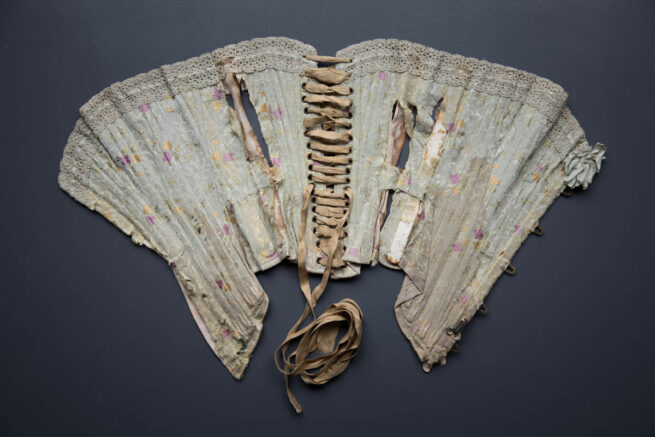 Silk Brocade Midbust Corset With Ribbon Slot Crochet Lace Trim, c. 1900s. The Underpinnings Museum. Photography by Tigz Rice