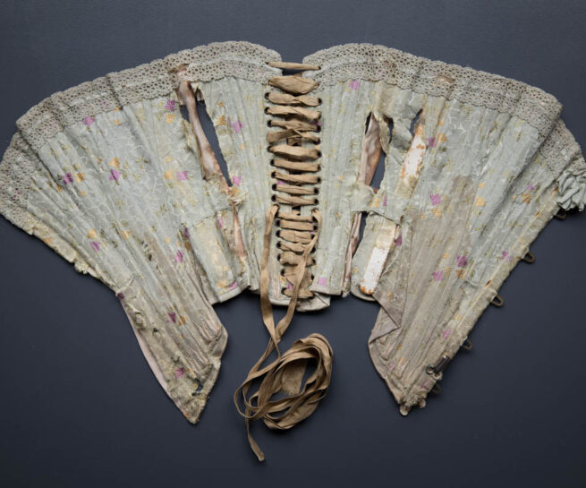 Silk Brocade Midbust Corset With Ribbon Slot Crochet Lace Trim, c. 1900s. The Underpinnings Museum. Photography by Tigz Rice